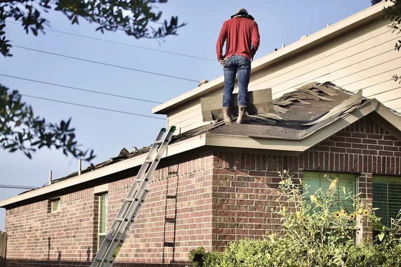 Professional roofer working on a residential roof in Porter Ranch